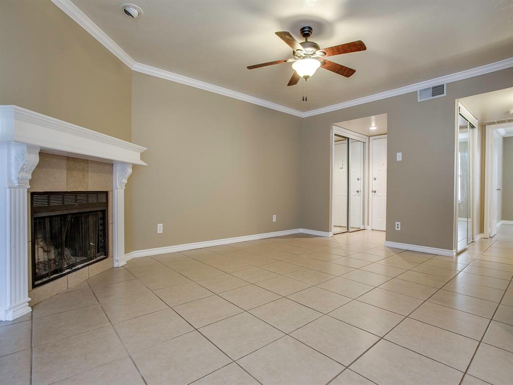 4492 Chaha Road, Unit 102 Garland, TX 75043 - Photo 26 of 40 an empty room with fan and fireplace