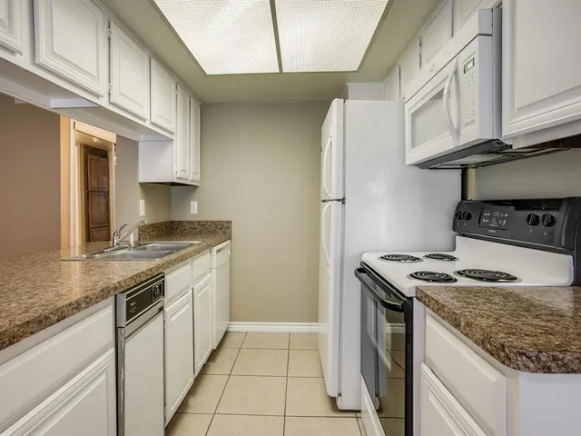 a kitchen with stainless steel appliances granite countertop a sink and cabinets