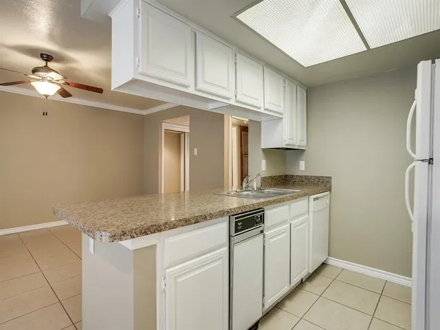 a kitchen with granite countertop a sink and a stove