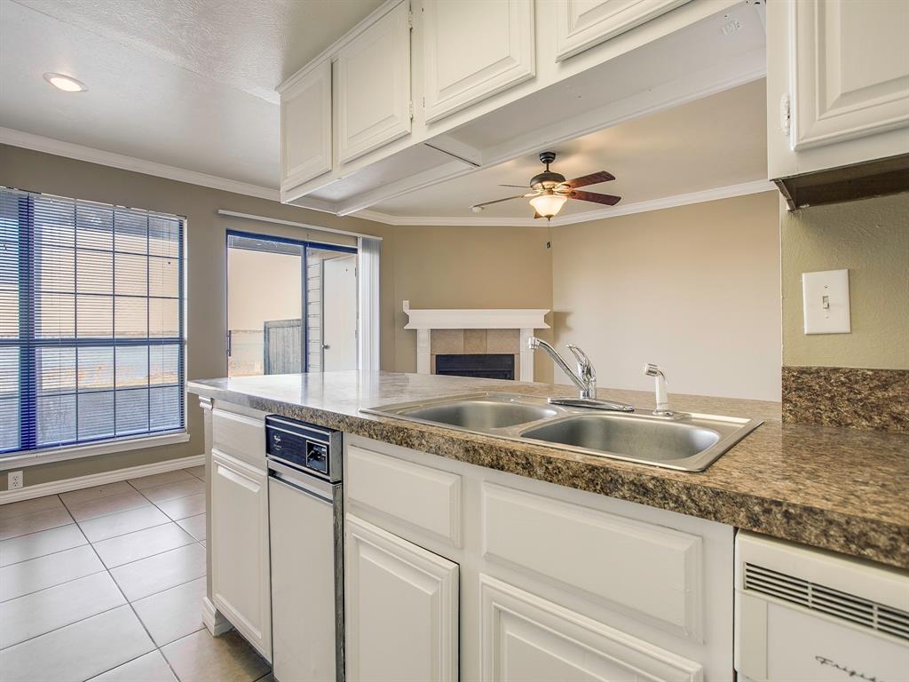 4492 Chaha Road, Unit 102 Garland, TX 75043 - Photo 31 of 40 a kitchen with granite countertop a sink and a stove