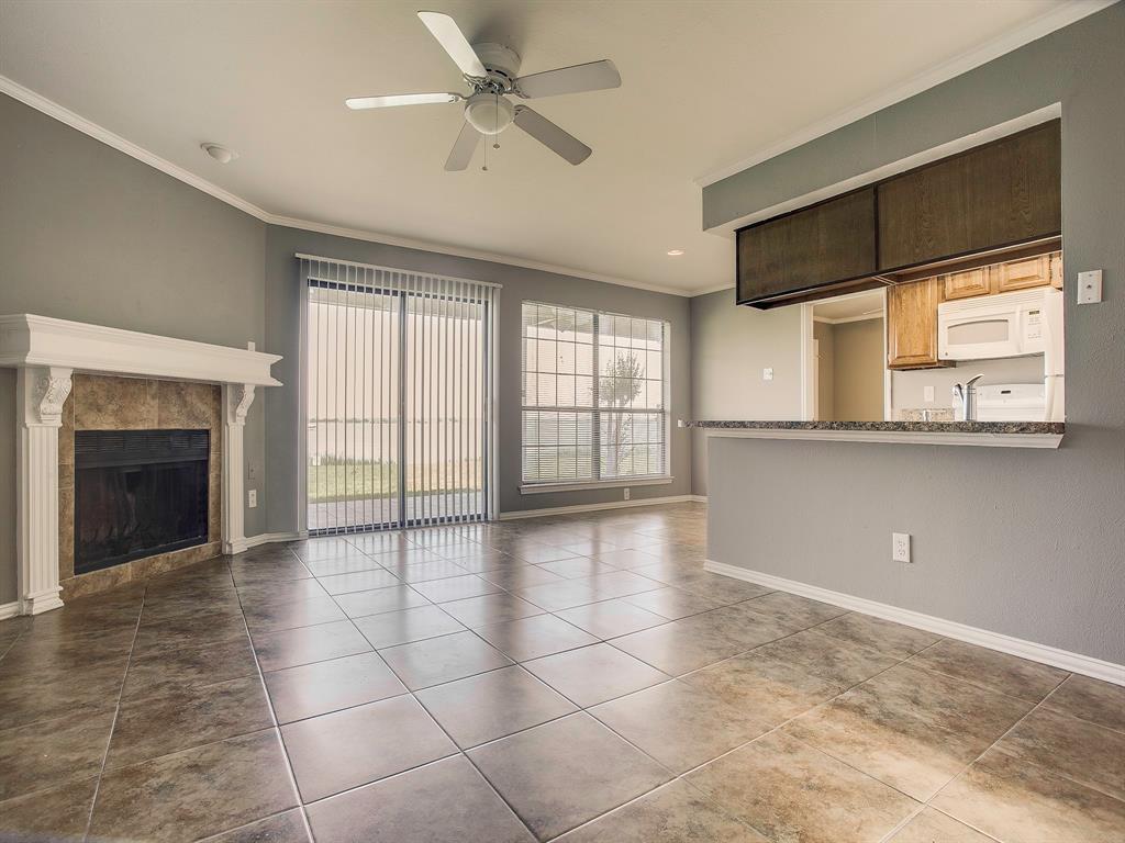 4492 Chaha Road, Unit 102 Garland, TX 75043 - Photo 4 of 40 a view of an empty room with a fireplace and a window