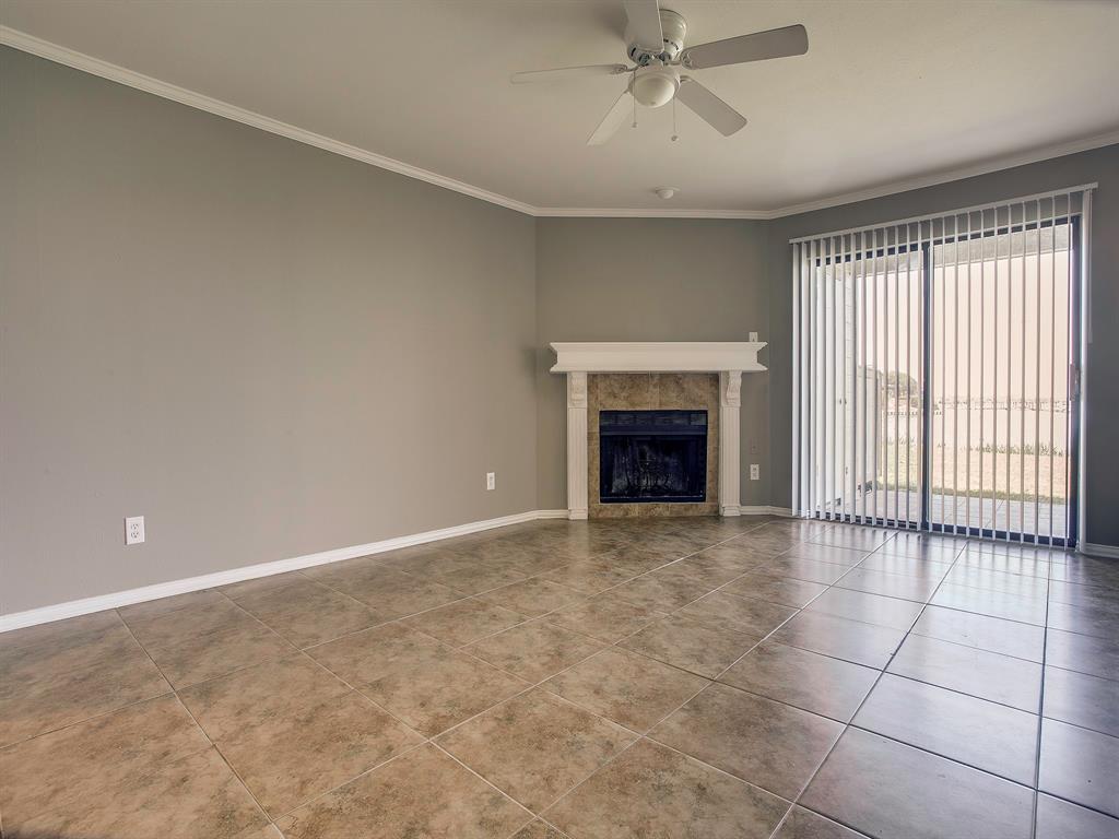4492 Chaha Road, Unit 102 Garland, TX 75043 - Photo 5 of 40 a view of an empty room with a fireplace and a window