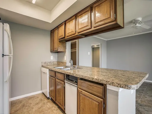 a kitchen with stainless steel appliances granite countertop a sink and cabinets