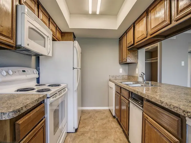 a kitchen with stainless steel appliances granite countertop a stove and a sink
