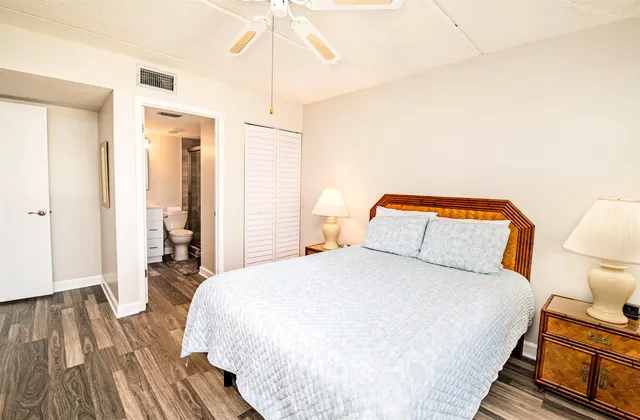 a bedroom with a bed and wooden floor