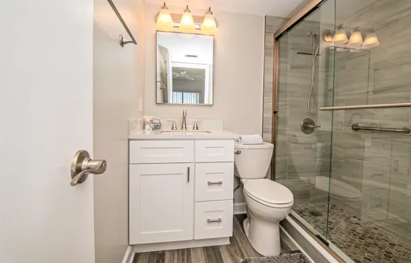 a bathroom with a toilet sink and shower