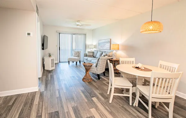 a view of a dining room with furniture wooden floor and chandelier