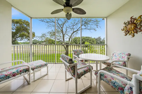 a roof deck with table and chairs and potted plants