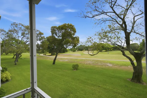 a view of a lake with a yard and trees