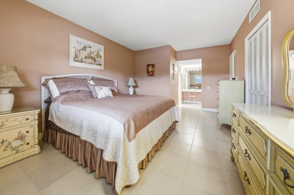 a bedroom with a bed and a dresser
