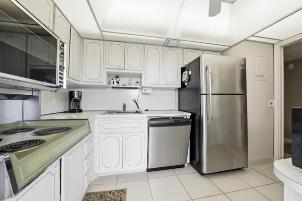 a kitchen with a white stove top oven and refrigerator