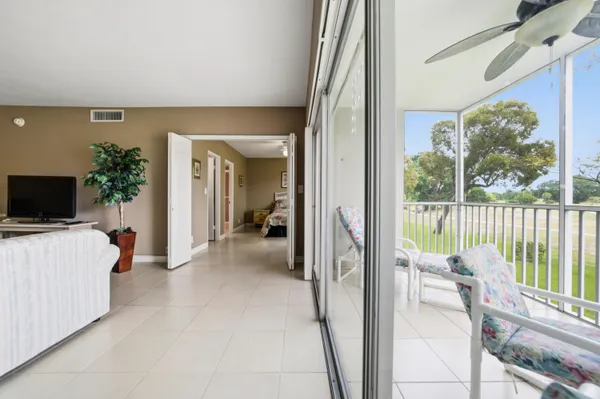 a view of a living room and a balcony