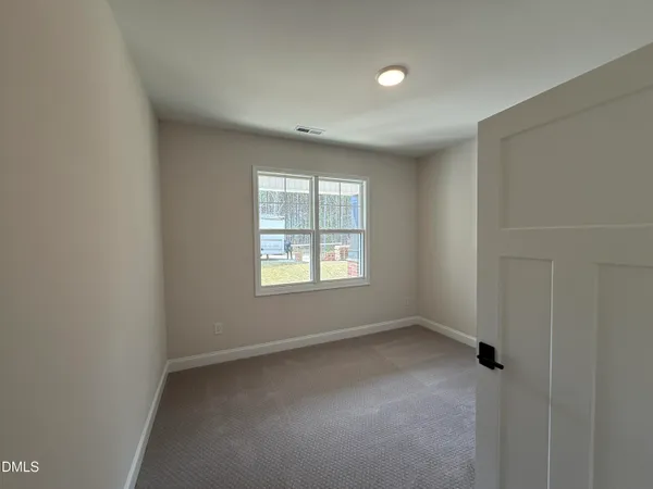 an empty room with a empty space and windows