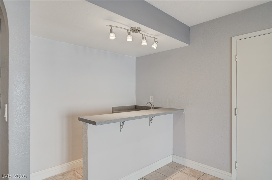 6635 Costa Brava Road Las Vegas, NV 89146 - Photo 22 of 59 A sleek wet bar, complete with a sink, offers a stylish spot for entertaining or daily refreshment.