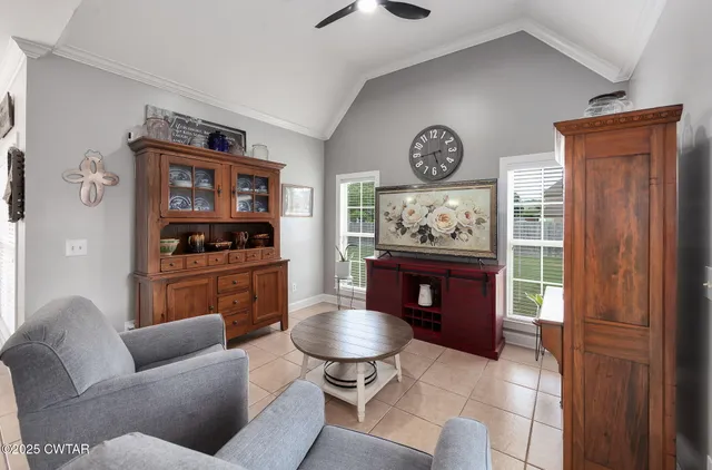 a living room with furniture and a wall painting