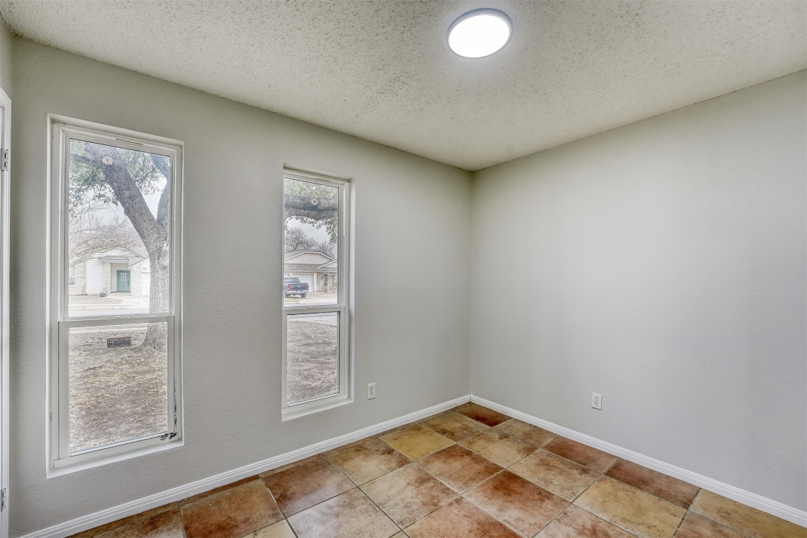 1002 Rambling Trail Cedar Park, TX 78613 - Photo 14 of 23 a view of an empty room with window and wooden floor