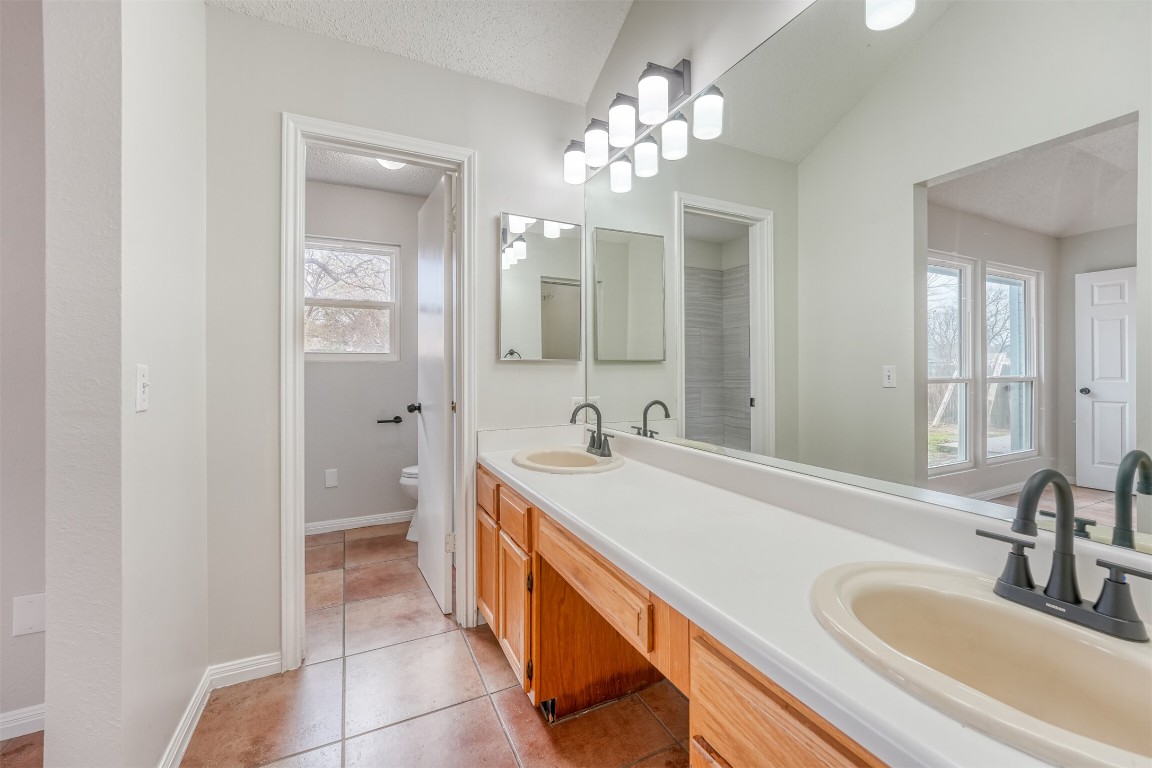 1002 Rambling Trail Cedar Park, TX 78613 - Photo 17 of 23 a bathroom with a sink double vanity granite and a mirror