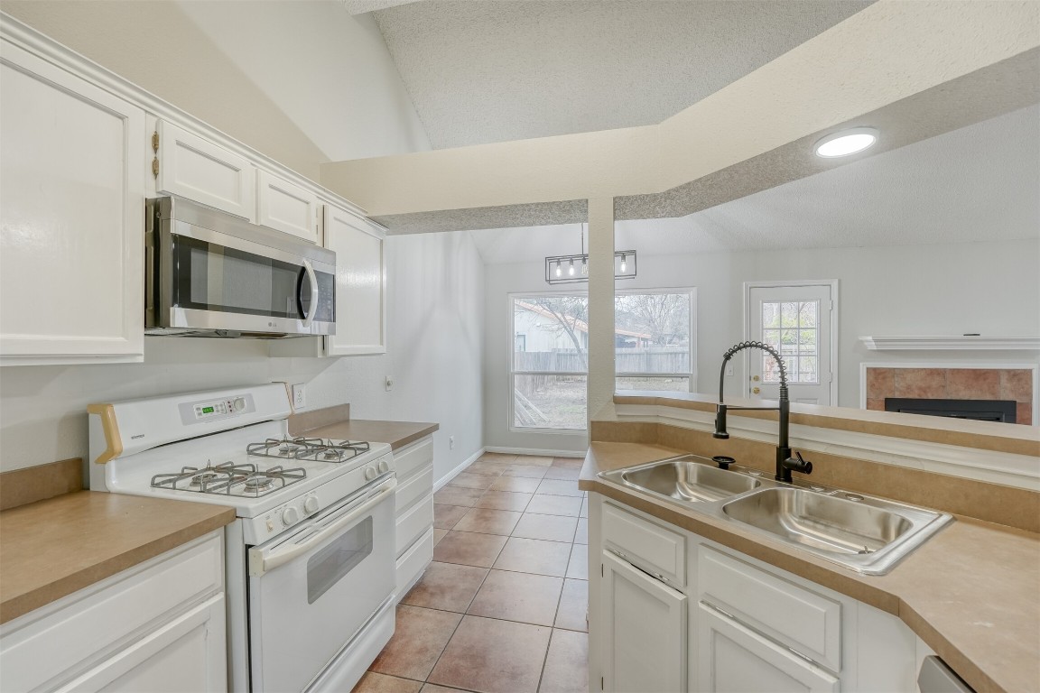 1002 Rambling Trail Cedar Park, TX 78613 - Photo 9 of 23 a kitchen with a sink appliances and cabinets