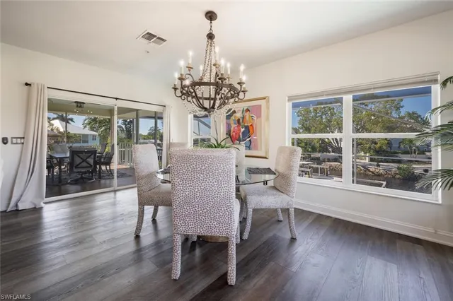 a large white kitchen with lots of counter space and stainless steel appliances