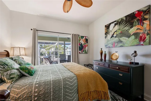 a bed sitting in a spacious bedroom next to a window
