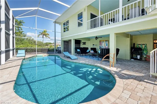 a view of a chairs and table in backyard