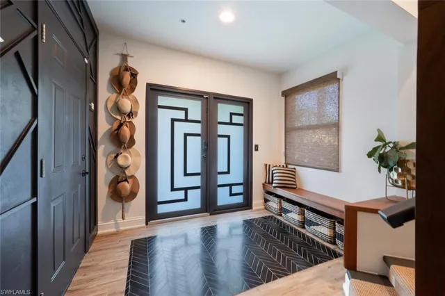a view of entryway and hall with wooden floor