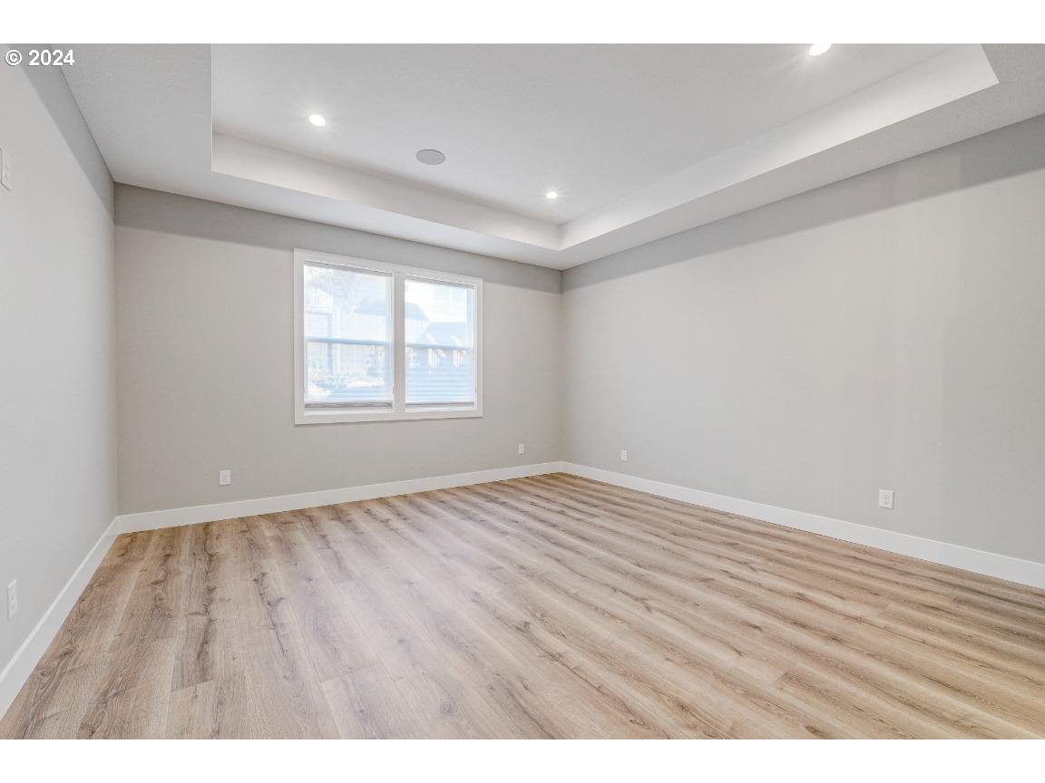 4120 South 17th Way Ridgefield, WA 98642 - Photo 11 of 20 an empty room with wooden floor and windows