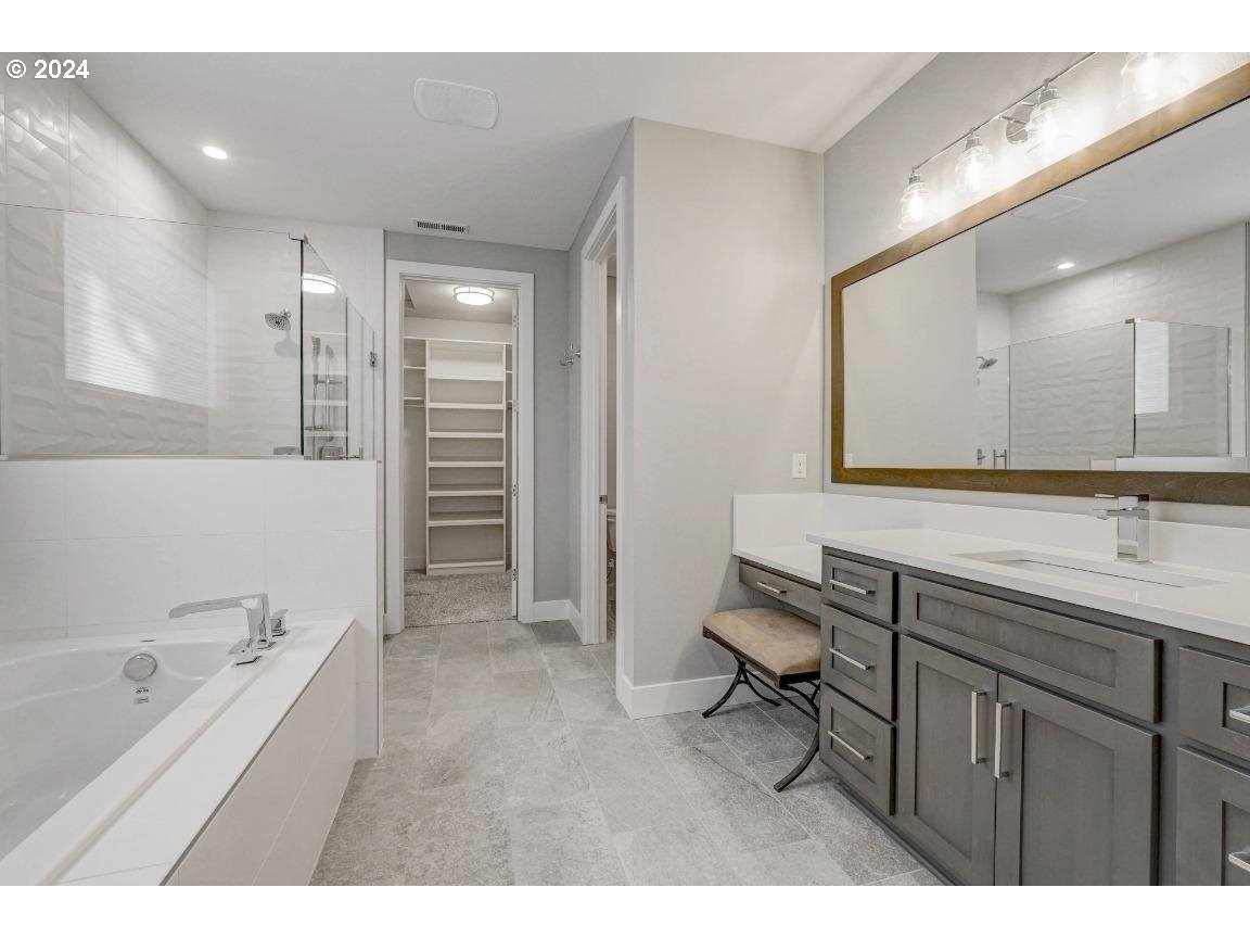 4120 South 17th Way Ridgefield, WA 98642 - Photo 12 of 20 a bathroom with a granite countertop sink mirror and bathtub