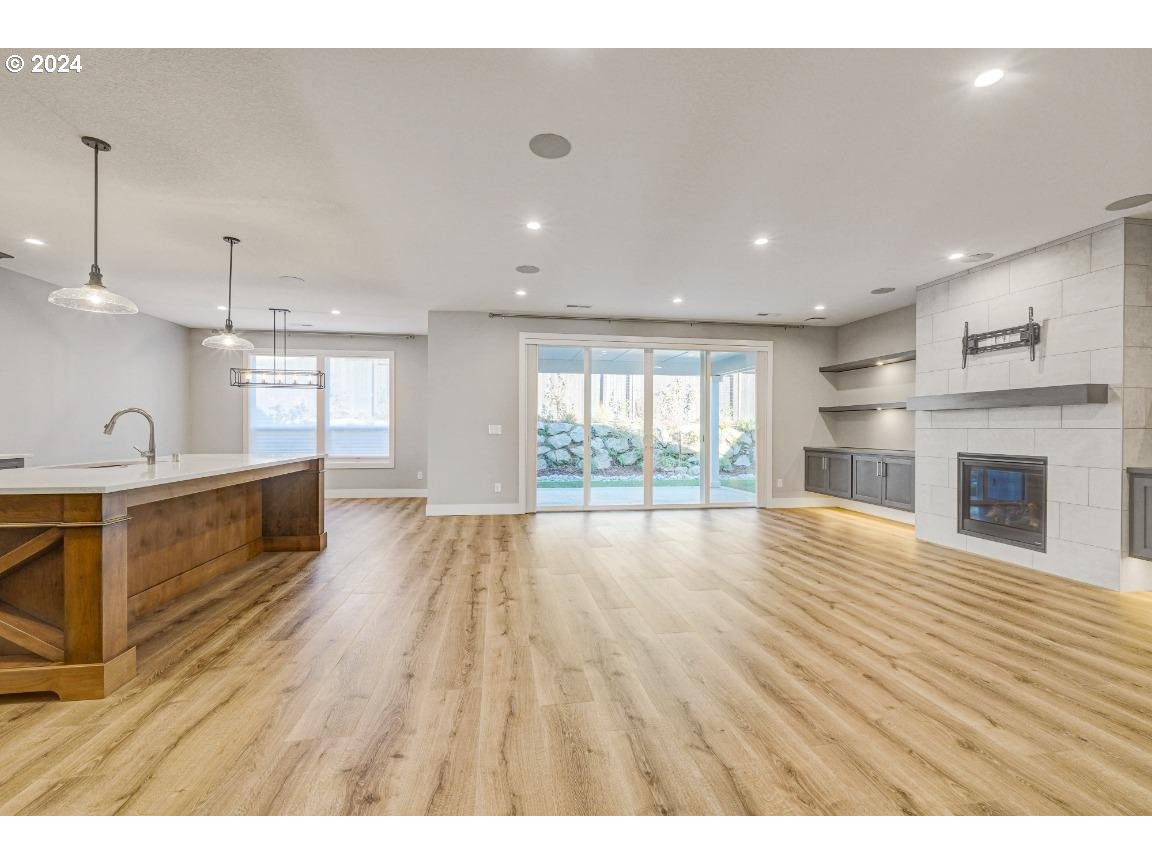 4120 South 17th Way Ridgefield, WA 98642 - Photo 5 of 20 a view of an empty room with wooden floor and a window