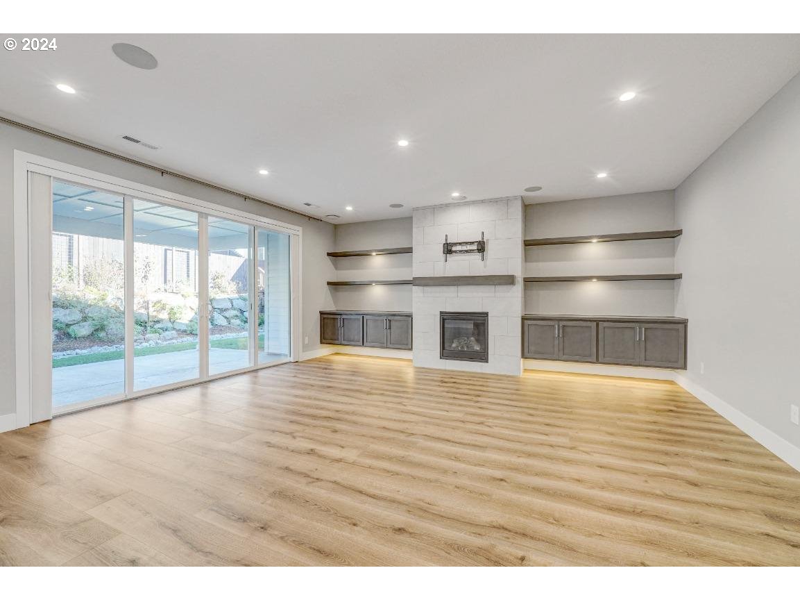4120 South 17th Way Ridgefield, WA 98642 - Photo 6 of 20 a view of empty room with wooden floor and fireplace