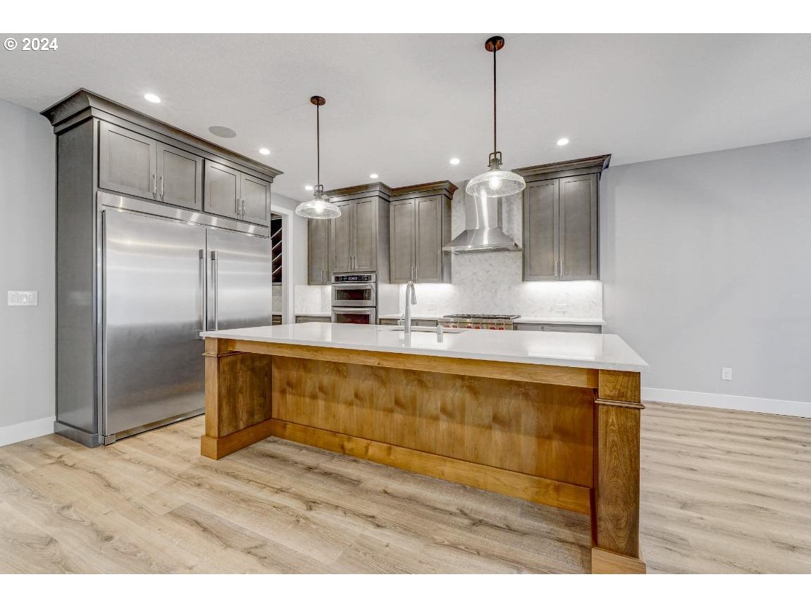 4120 South 17th Way Ridgefield, WA 98642 - Photo 8 of 20 a kitchen with kitchen island a counter top space appliances and cabinets