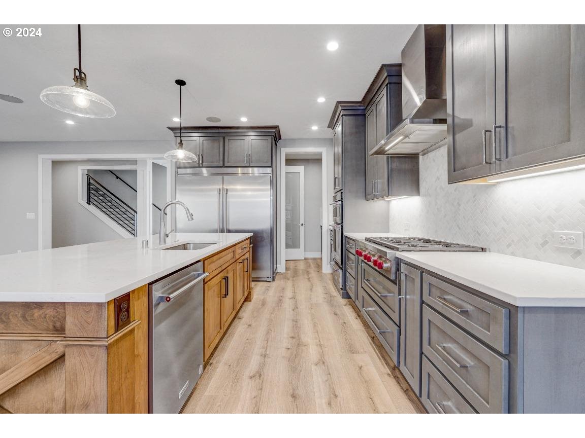 4120 South 17th Way Ridgefield, WA 98642 - Photo 9 of 20 a kitchen with stainless steel appliances granite countertop a sink a stove and a refrigerator