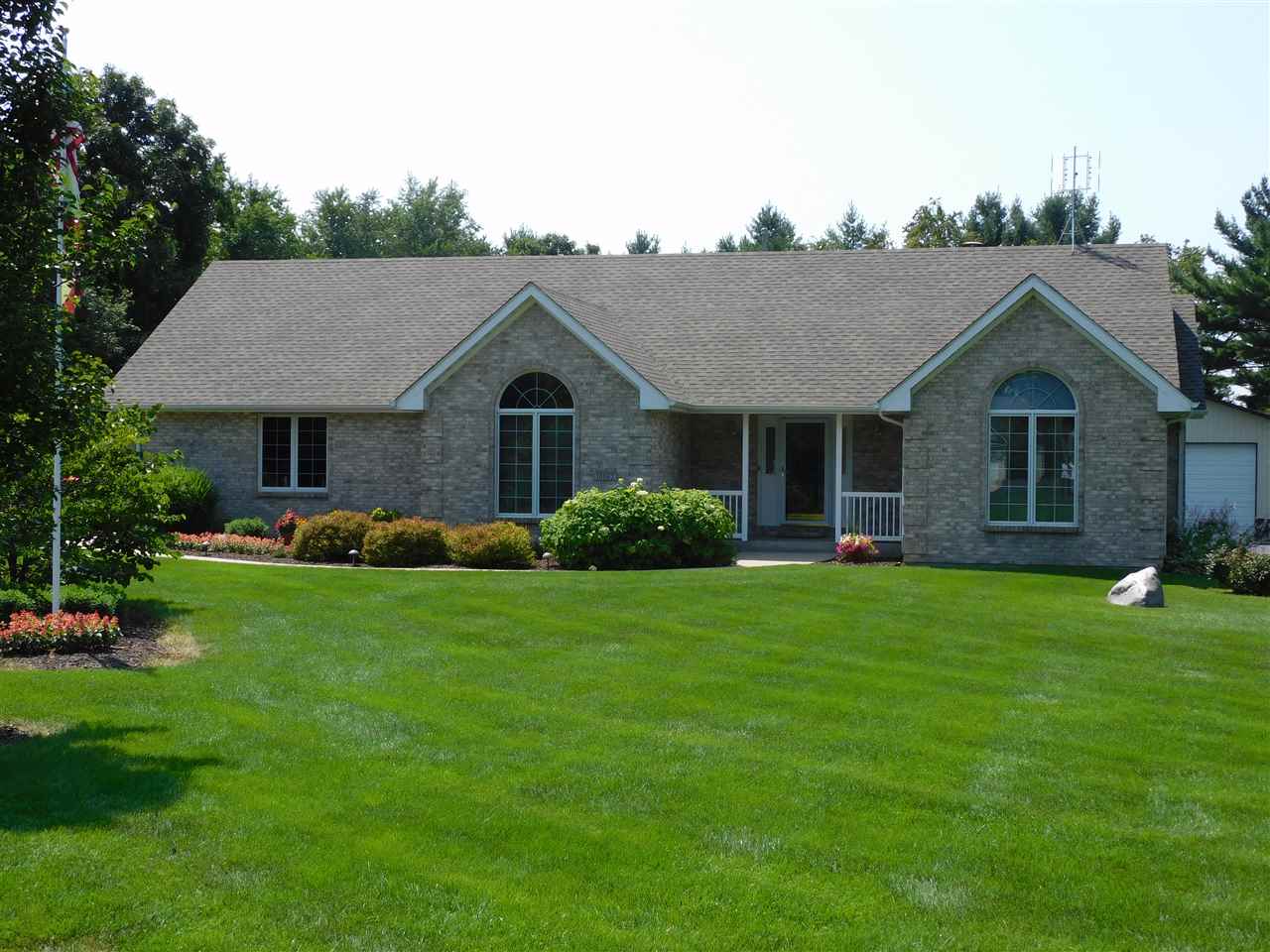 10062 Beaver Valley Road Belvidere, IL 61008 - Photo 1 of 25 a front view of a house with a garden
