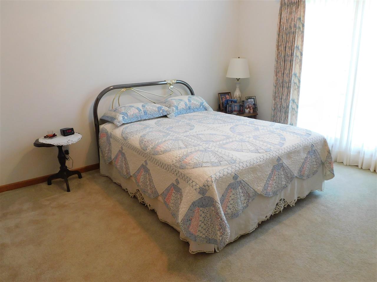 10062 Beaver Valley Road Belvidere, IL 61008 - Photo 13 of 25 a bed sitting in a bedroom next to a window