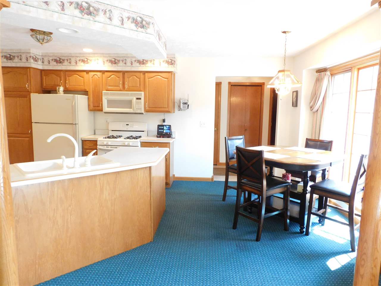 10062 Beaver Valley Road Belvidere, IL 61008 - Photo 5 of 25 a kitchen with kitchen island a stove a table and chairs