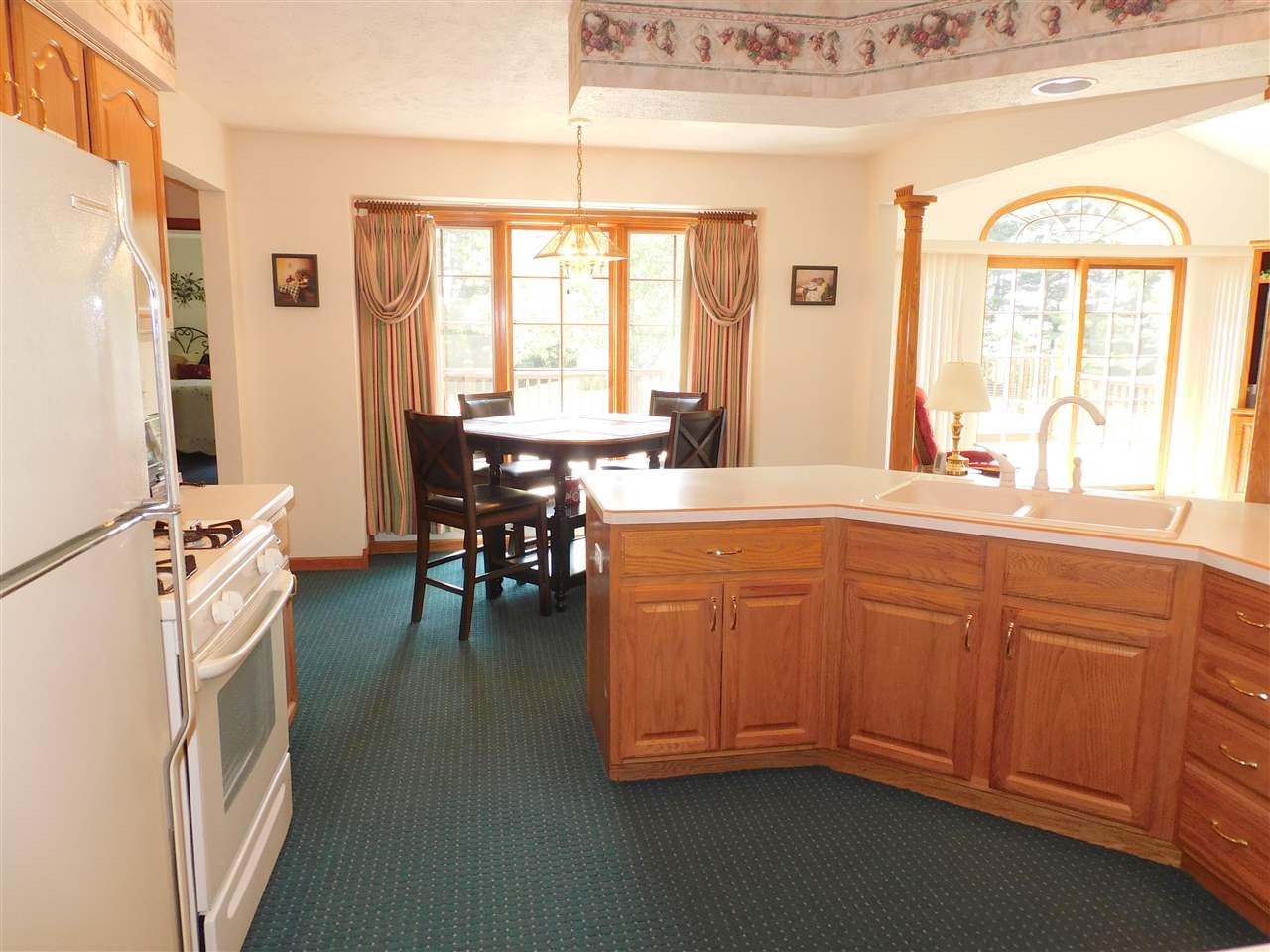 10062 Beaver Valley Road Belvidere, IL 61008 - Photo 6 of 25 a kitchen with stainless steel appliances granite countertop a stove a sink dishwasher and a dining table with wooden cabinet