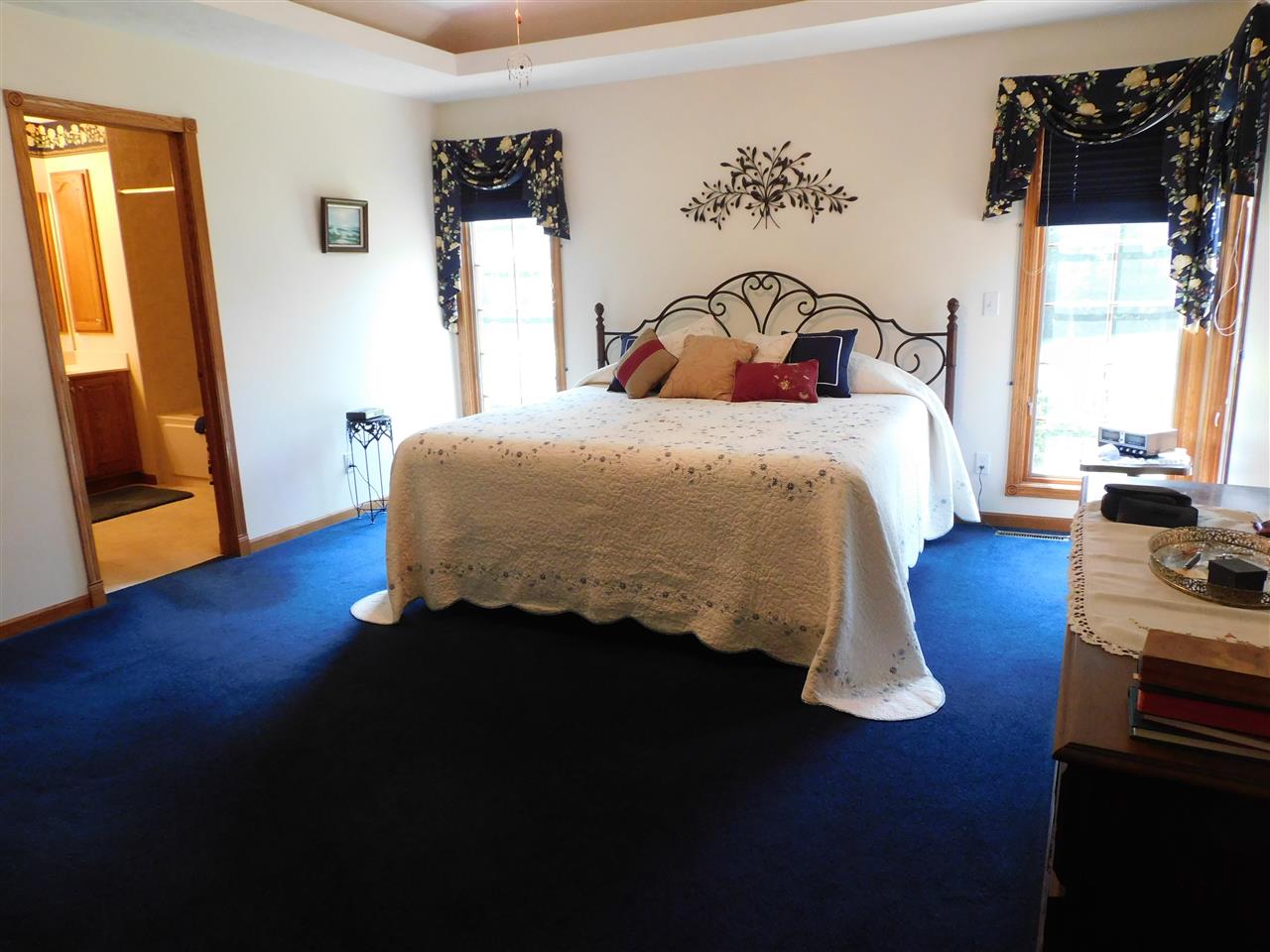 10062 Beaver Valley Road Belvidere, IL 61008 - Photo 9 of 25 a bedroom with a bed and wooden floor