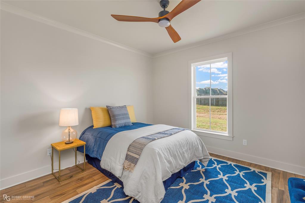 219 Marble Place Haughton, LA 71037 - Photo 27 of 29 Bright room with wood-finish flooring, a contemporary ceiling fan, and a large window
