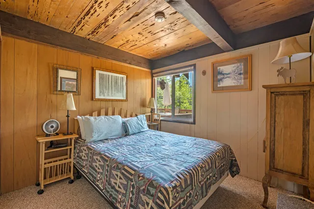 a bed sitting in a bedroom next to a window