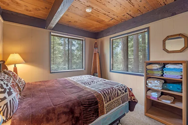 a bed sitting in a bedroom next to a window