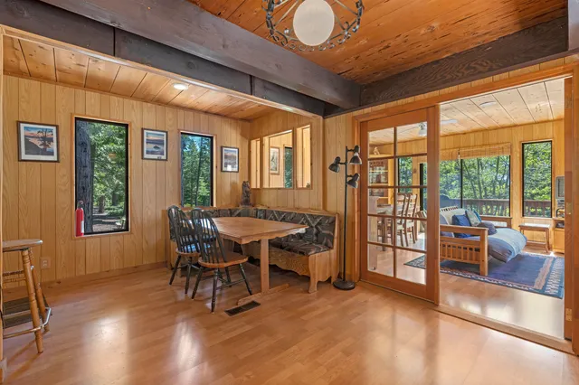 a dining room with furniture a chandelier and wooden floor