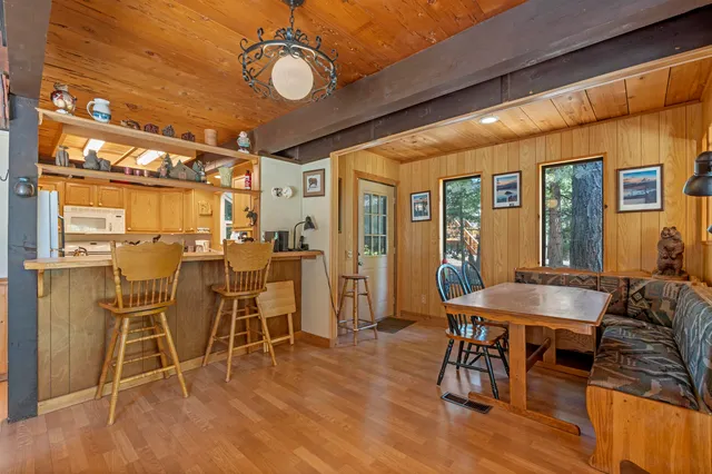a kitchen with stainless steel appliances granite countertop a sink a stove and cabinets