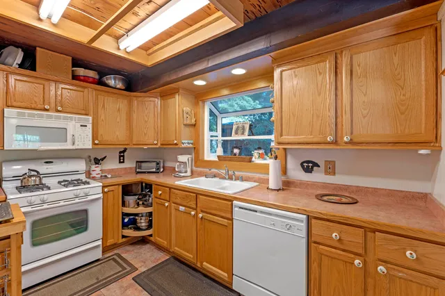 a white refrigerator freezer and a microwave oven in a kitchen