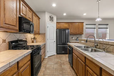 a kitchen with kitchen island a dining table and chairs