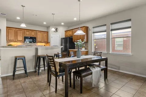 a kitchen with a stove a sink a refrigerator and a stove