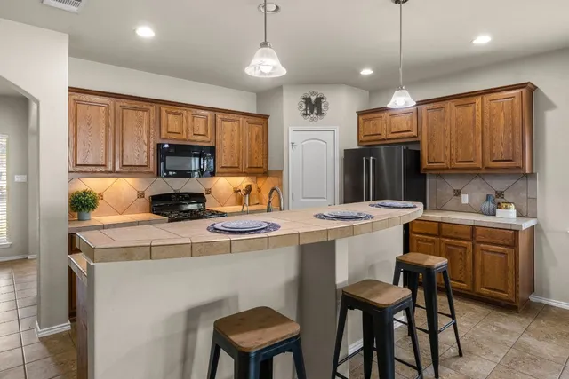 a kitchen with a stove a sink a refrigerator and a stove