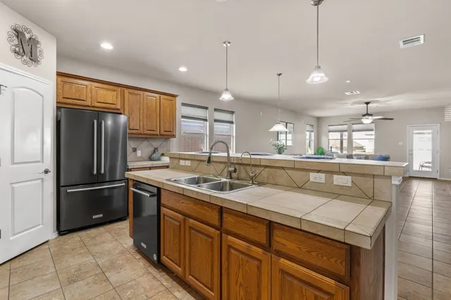 a kitchen with wooden cabinets and a stove top oven