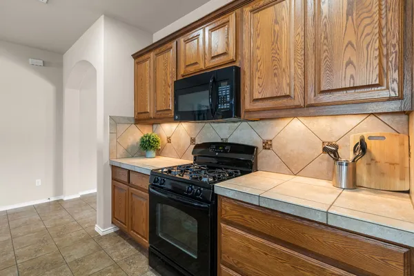 a kitchen with stainless steel appliances granite countertop a sink and stove