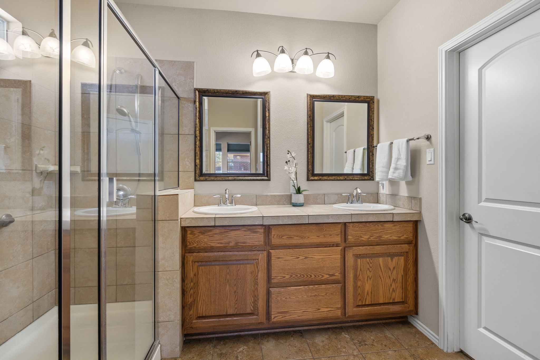 221 Blossom Valley Streme Buda, TX 78610 - Photo 24 of 40 a bathroom with a double vanity sink and a mirror