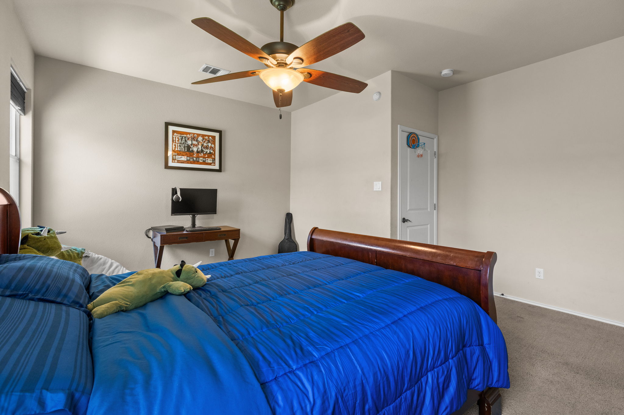 221 Blossom Valley Streme Buda, TX 78610 - Photo 31 of 40 a bedroom with a bed and a chandelier